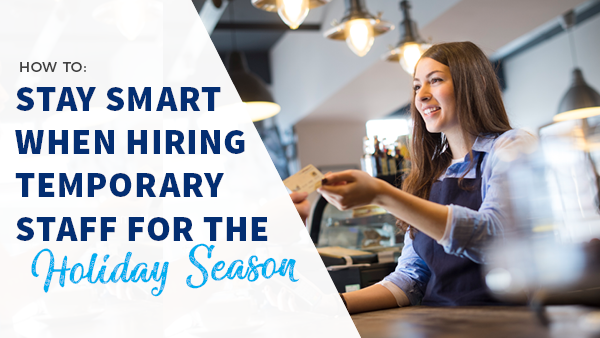 female clerk handing card to holiday shopper